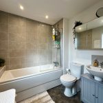 Modern bathroom with bathtub, sink, and toilet