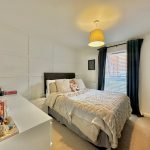 Cosy bedroom with double bed and soft toys.
