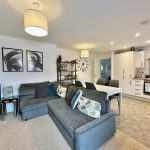 Modern open-plan living room and kitchen interior.