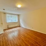 Bright empty room with wooden flooring