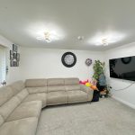 Modern living room with beige corner sofa.
