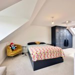 Modern loft bedroom with skylight and wardrobe