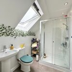 Modern bathroom with skylight and glass shower.
