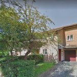 Detached house with driveway and trees