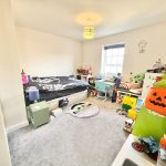 Children's bedroom with toys and colourful decor.