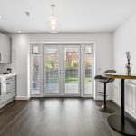 Modern kitchen with view of garden patio doors.