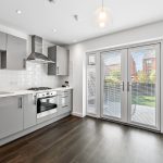 Modern kitchen with grey cabinets and garden view