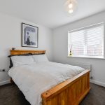 Modern bedroom with wooden bed and decor