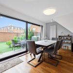 Modern dining room with garden view.