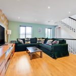 Bright living room with sofas and television.
