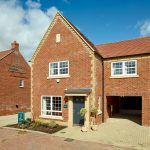 Newly built brick houses under blue sky.