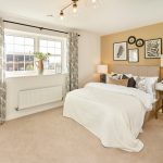 Modern bedroom with double bed and decor.