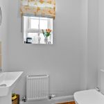 Small bathroom with tulips on windowsill