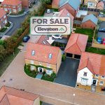 Aerial view of house for sale in neighbourhood.