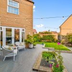 Modern garden with patio and outdoor seating.