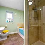 Modern bathroom with shower, toilet, and bathtub.
