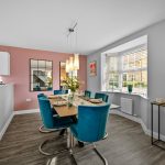Modern dining room with teal chairs and decor