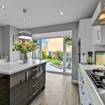 Modern kitchen with island and patio view.