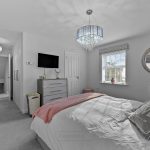 Modern bedroom with chandelier and wall mirror