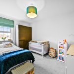 Modern children's bedroom with cot and storage