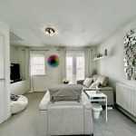 Modern living room with grey sofas and abstract art.