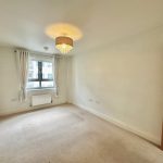 Empty room with window, carpet, and ceiling light.