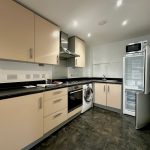 Modern kitchen with appliances and cabinets.