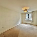 Empty room with window, curtains, chandelier.