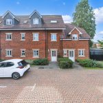 Brick house with parked cars outside
