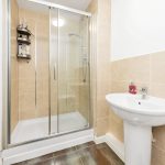 Modern bathroom with shower and sink.