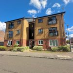 Modern brick apartment building under blue sky