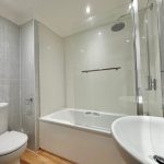 Modern bathroom with shower and bathtub.