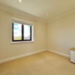 Empty room with window and chest of drawers