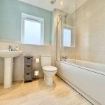 Modern bathroom with shower and sink.