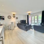 Modern open-plan living room with kitchen and dining area.