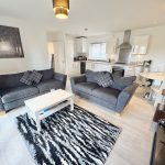 Modern open-plan living room and kitchen area.