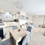 Modern open-plan kitchen and living room design.