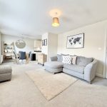 Modern living and dining room with grey decor.
