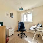 Bright home office with desk and laptop