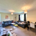 Spacious living room with sofas and dining table.