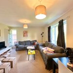 Modern living room with sofas and boxes.