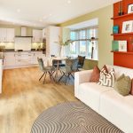 Modern open-plan kitchen and living area with decor.