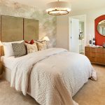 Elegant bedroom with modern decor and warm lighting.