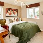 Modern bedroom with green bedding and abstract artwork.
