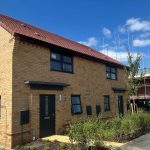 New brick townhouse under blue sky