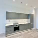 Modern grey kitchen with integrated appliances.