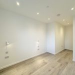 Empty room with wooden floor and white walls.