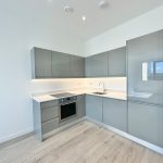 Modern grey kitchen with integrated appliances.