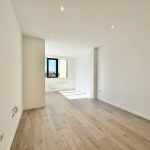 Bright empty room with wooden floor and window
