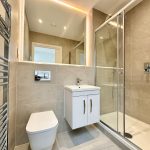 Modern bathroom with shower and heated towel rail.